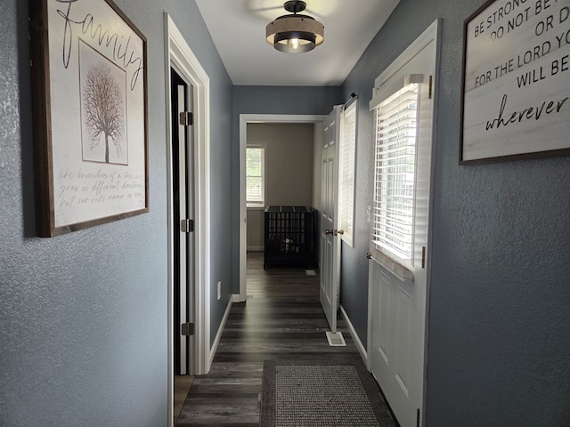 1701 Boyd, Chillicothe, MO 64601 - hall featuring dark wood-style floors and a textured wall