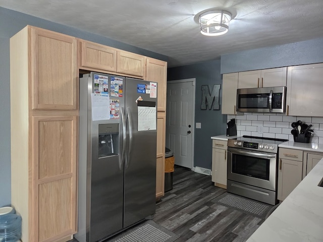 1701 Boyd, Chillicothe, MO 64601 - kitchen featuring appliances with stainless steel finishes, decorative backsplash, dark wood finished floors, light brown cabinets, and light stone counters