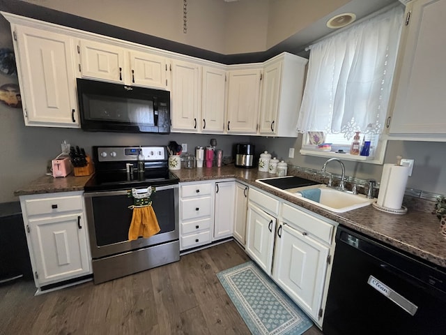 kitchen featuring white cabinetry, black appliances, dark countertops, and a sink