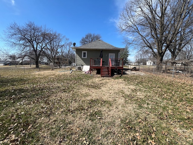 rear view of house featuring a fenced backyard, a yard, a deck, and stairway