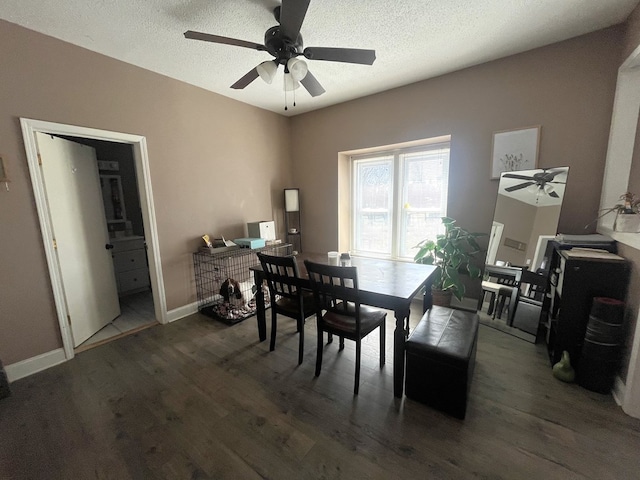 dining area featuring baseboards, a textured ceiling, ceiling fan, and wood finished floors