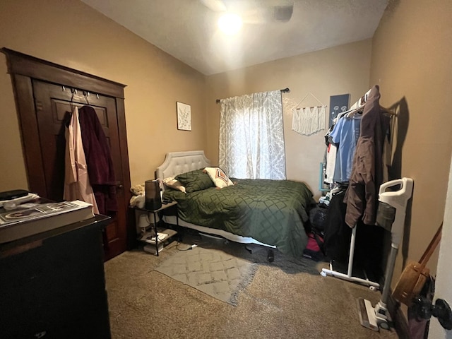 bedroom with ceiling fan, carpet flooring, and vaulted ceiling