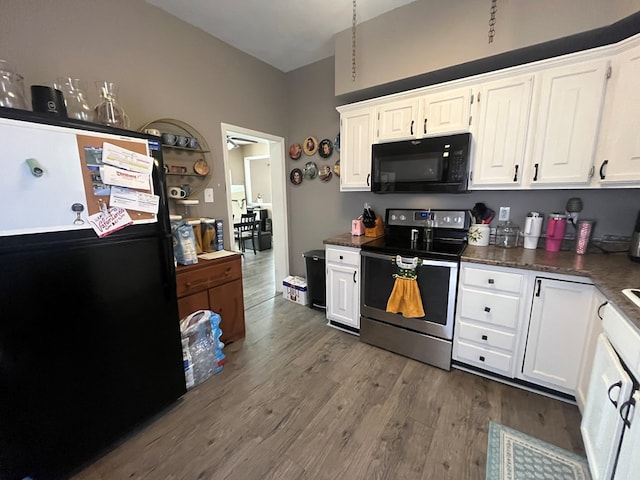 kitchen featuring dark countertops, black appliances, dark wood-style flooring, and white cabinetry