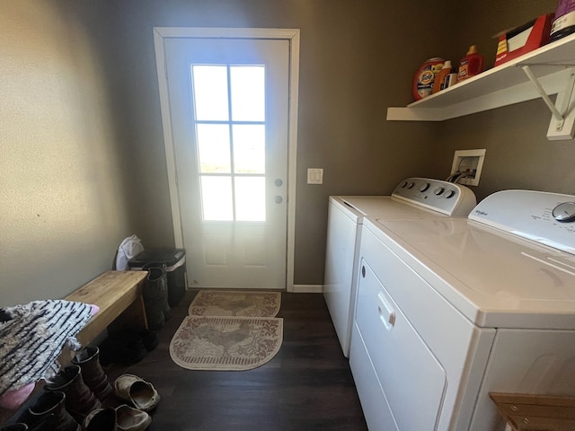 laundry area featuring dark wood finished floors, laundry area, and washer and clothes dryer