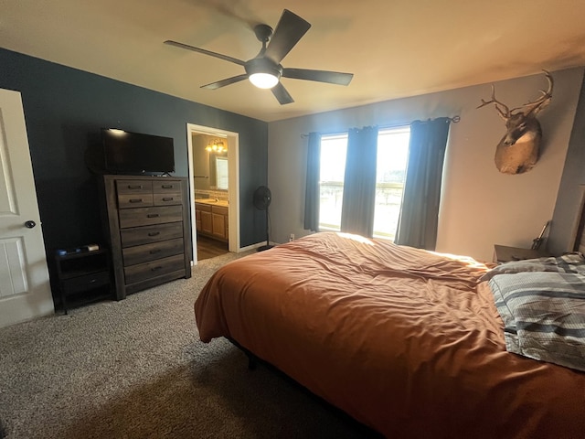 bedroom featuring light carpet, visible vents, ensuite bathroom, and a ceiling fan