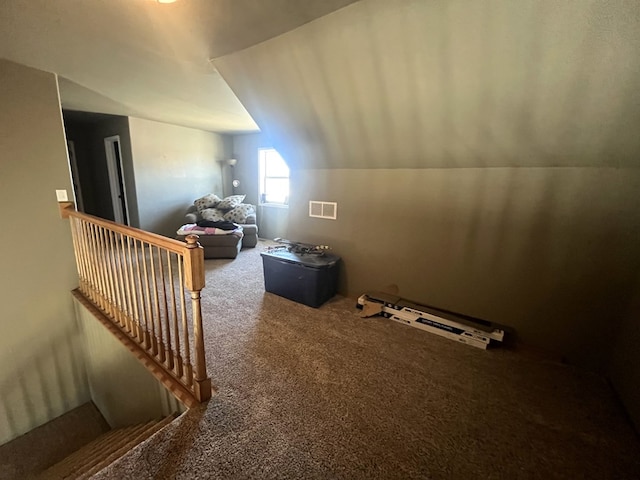 additional living space featuring vaulted ceiling, carpet, and visible vents