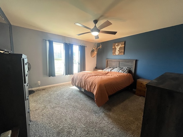 carpeted bedroom featuring a ceiling fan and baseboards