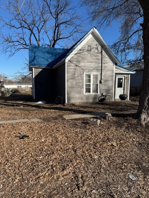 view of side of home featuring metal roof