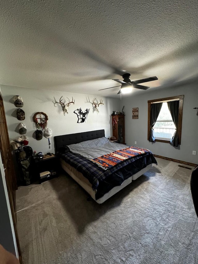 bedroom featuring carpet, ceiling fan, and a textured ceiling