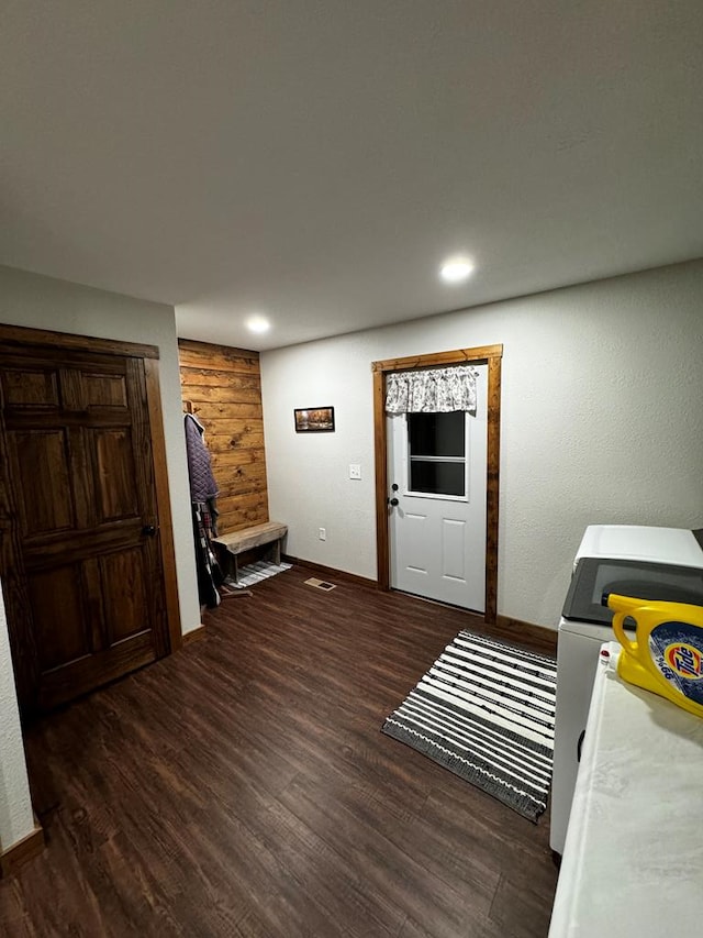 foyer entrance with separate washer and dryer and dark hardwood / wood-style floors