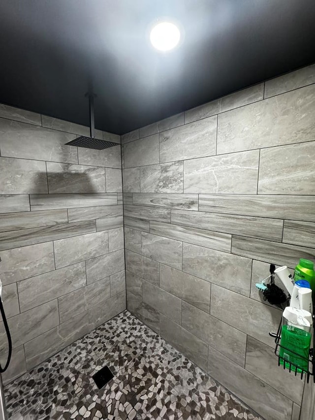 bathroom with tiled shower