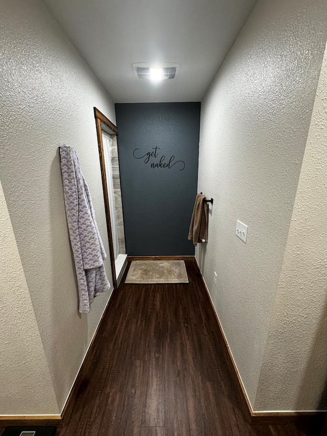 corridor featuring hardwood / wood-style floors