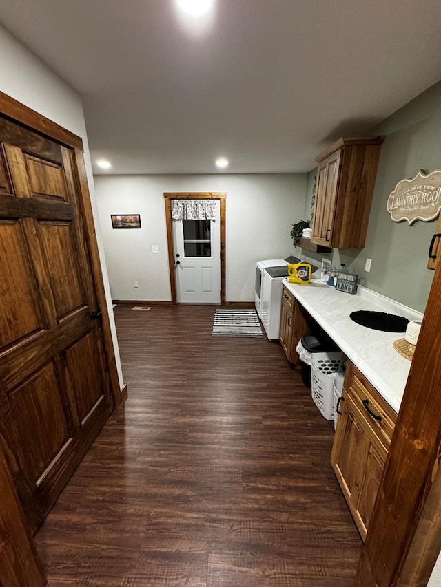 kitchen featuring washer and dryer and dark hardwood / wood-style floors