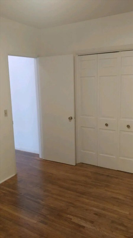 117 N Rollins St, Macon, MO 63552 - unfurnished bedroom featuring wood finished floors and a closet