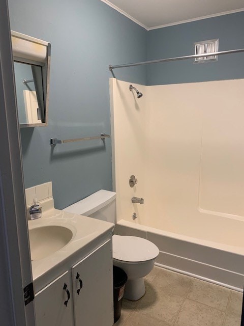 full bathroom with tile patterned flooring, toilet, vanity,  shower combination, and crown molding