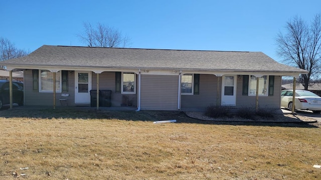 ranch-style house with covered porch, a shingled roof, and a front yard