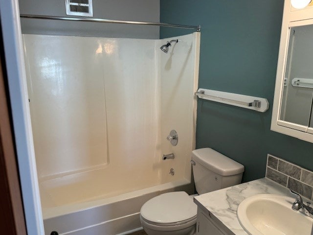 bathroom with vanity, toilet, and shower / bathtub combination