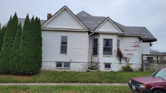 view of side of property with a lawn