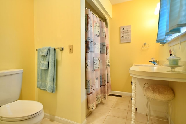 full bathroom featuring tile patterned floors, toilet, shower / bath combination with curtain, and sink