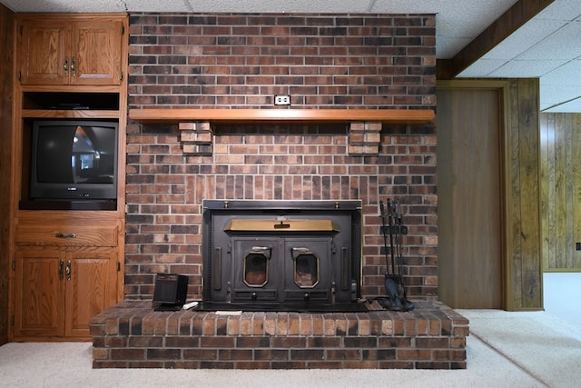 details with carpet flooring, a wood stove, and wooden walls