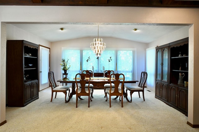 dining space with light colored carpet, vaulted ceiling, and an inviting chandelier