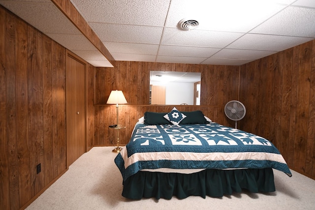 bedroom featuring wood walls and carpet floors