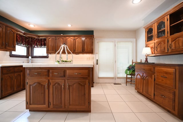 kitchen featuring tile counters, sink, and light tile patterned floors