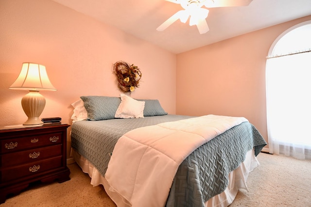 bedroom featuring ceiling fan and light carpet