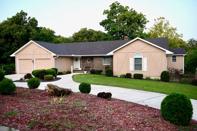 ranch-style home featuring a front lawn and a garage