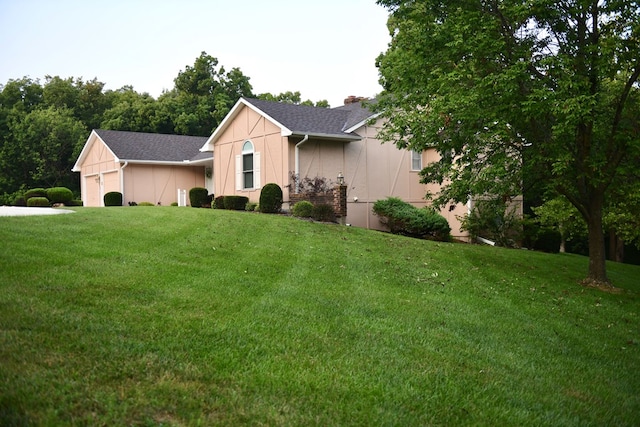 ranch-style house featuring a garage and a front yard