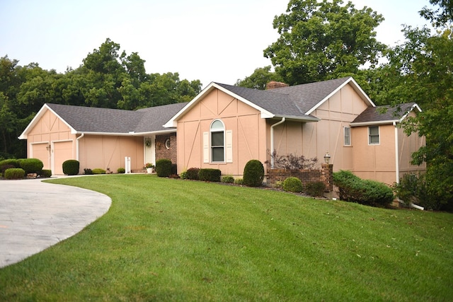 single story home with a garage and a front lawn