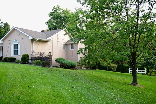 view of side of home featuring a yard