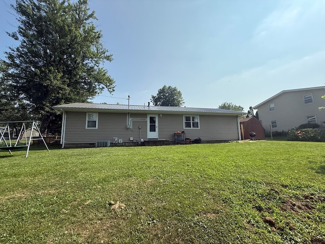 4 Grim Ct N, Kirksville, MO 63501 - rear view of house with a storage unit, a yard, and a metal roof