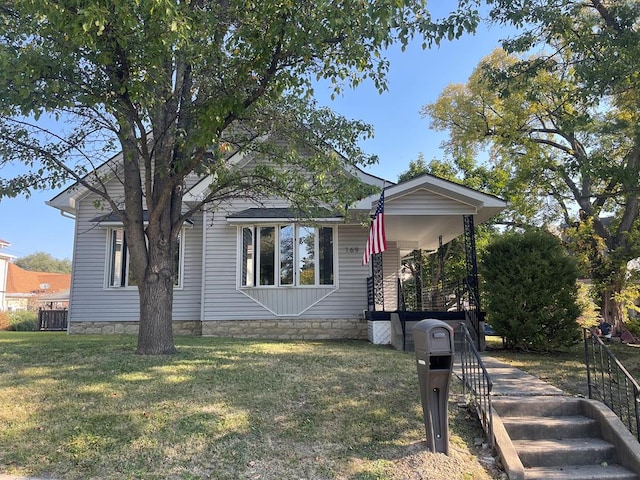 view of front of property with a porch and a front yard