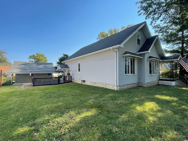 view of side of property with a deck and a yard