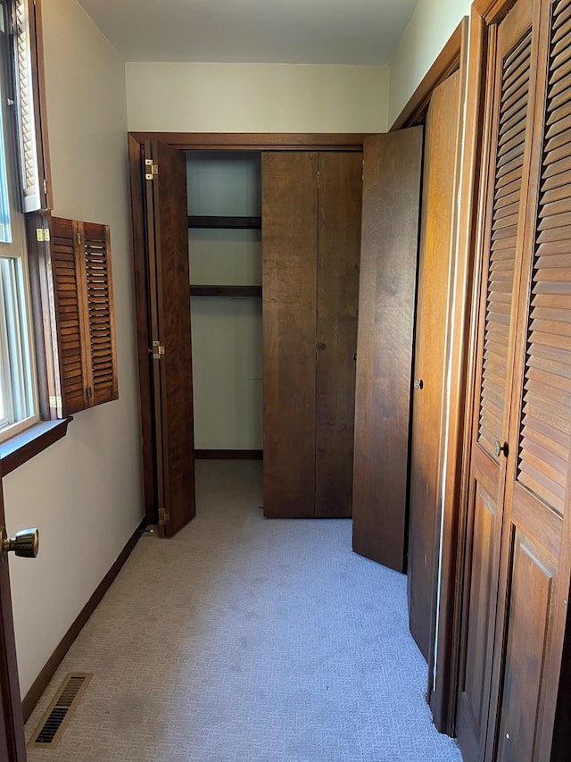 unfurnished bedroom featuring light carpet