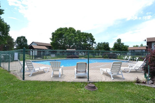 community pool featuring a yard, a patio, and fence