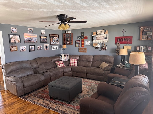 living room featuring a textured ceiling, a ceiling fan, and wood finished floors