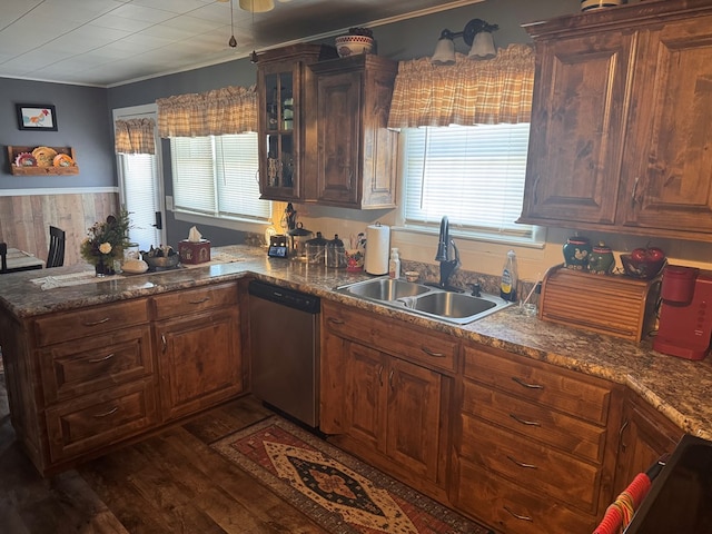 kitchen with dark wood finished floors, stainless steel dishwasher, glass insert cabinets, a sink, and a peninsula