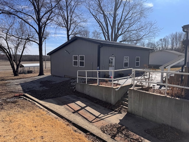 rear view of property with a vegetable garden