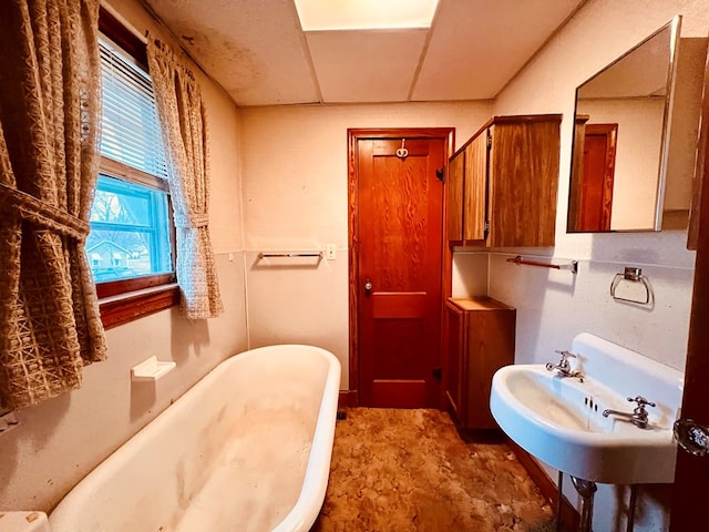 bathroom with a sink and a freestanding bath