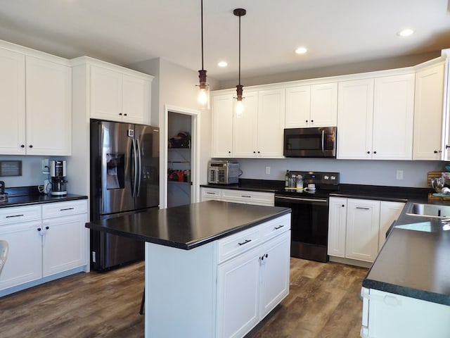 1109 Steer Creek Way, Kirksville, MO 63501 - kitchen with dark wood-style floors, appliances with stainless steel finishes, dark countertops, and white cabinets