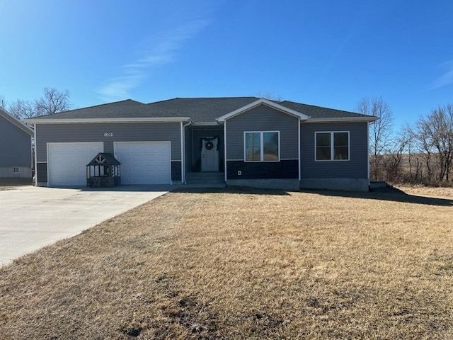 ranch-style home featuring a garage, a front yard, and driveway