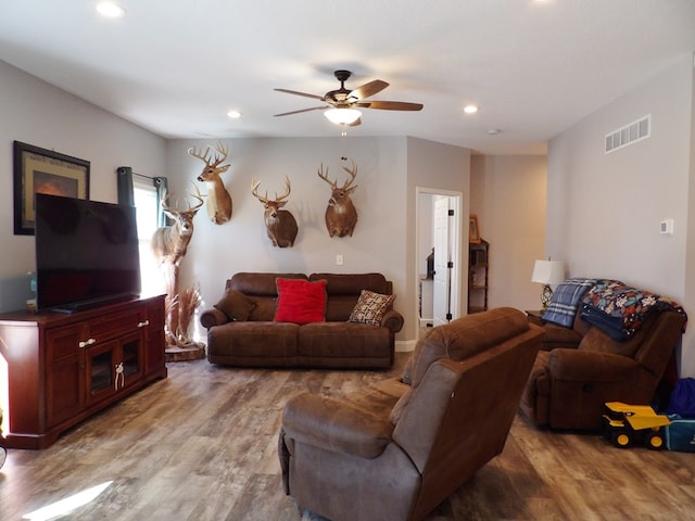 living room featuring light wood-type flooring, visible vents, a ceiling fan, and recessed lighting