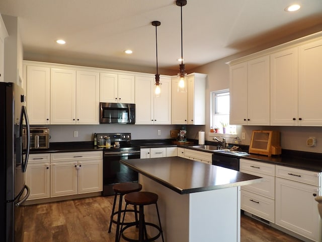 1109 Steer Creek Way, Kirksville, MO 63501 - kitchen featuring recessed lighting, a sink, white cabinets, black appliances, and dark countertops