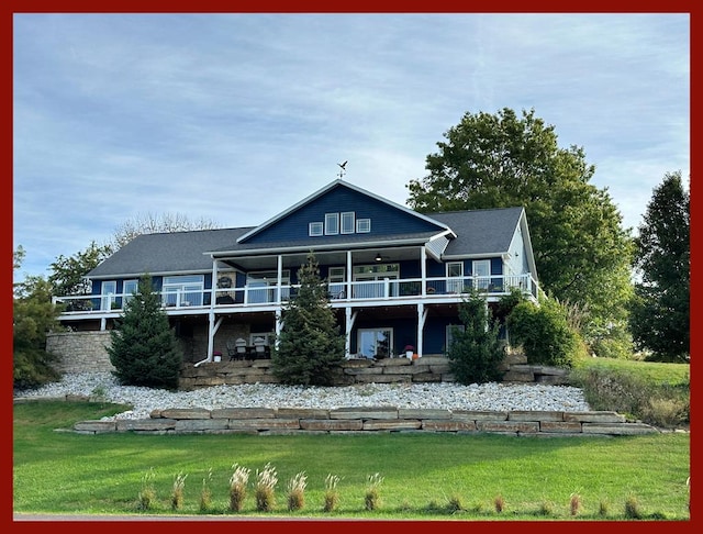 rear view of house featuring a deck, ceiling fan, and a lawn