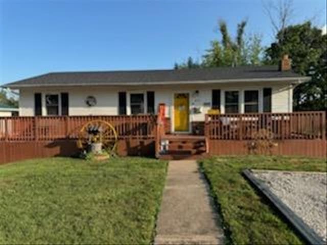 816 Locust St, Macon, MO 63552 - single story home with a wooden deck, a front lawn, and a chimney
