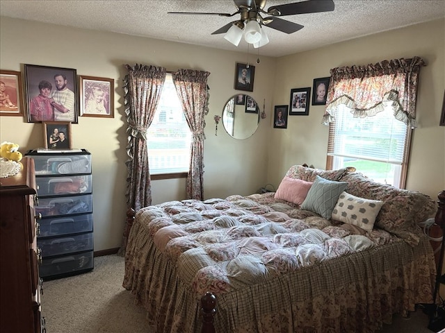 816 Locust St, Macon, MO 63552 - bedroom with carpet, multiple windows, ceiling fan, and a textured ceiling