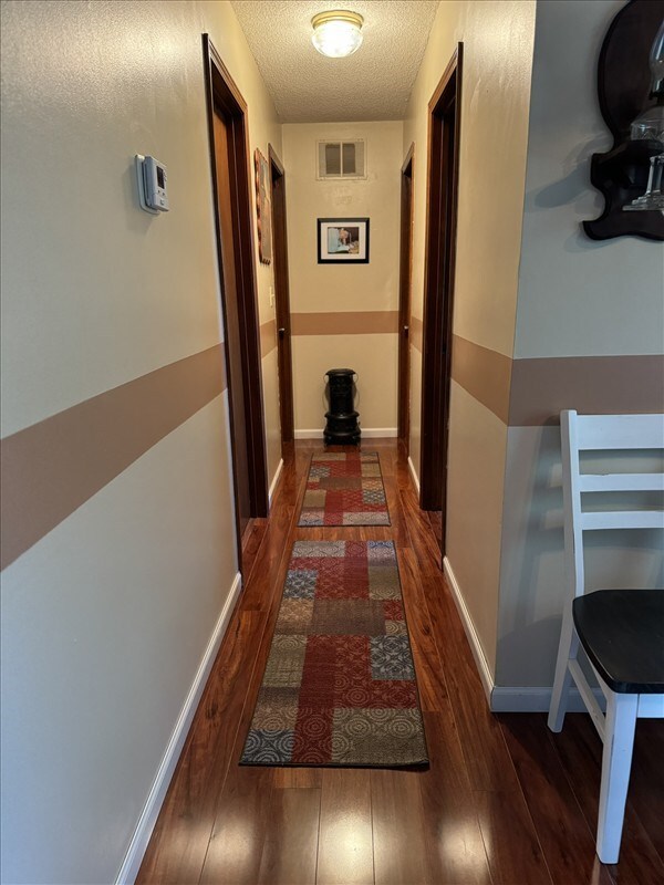 816 Locust St, Macon, MO 63552 - corridor with wood finished floors and a textured ceiling
