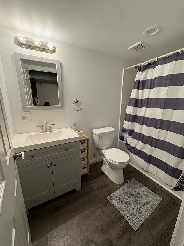 bathroom featuring a shower with curtain, vanity, wood-type flooring, and toilet